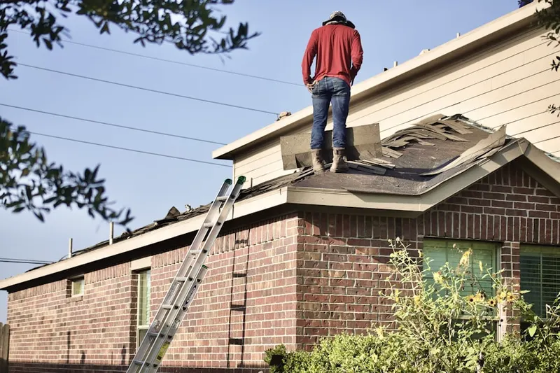 Professional roofer working on a residential roof in Taylor Center